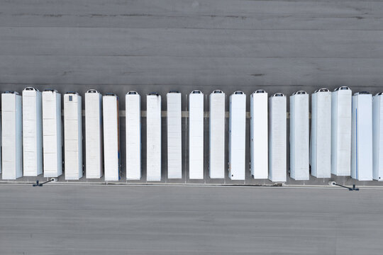 Aerial view of semi-truck trailers parked in neat rows at a warehouse facility in Eagle Mountain, Utah, United States.