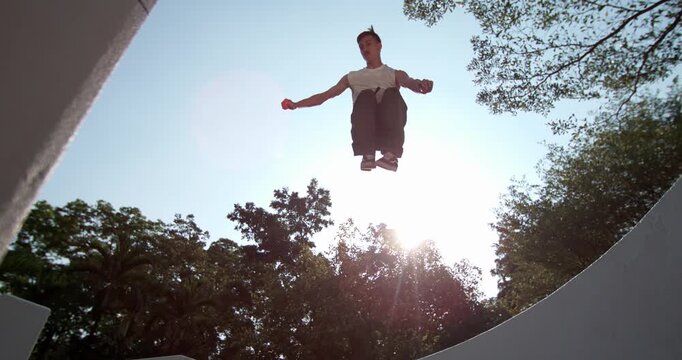 Cinematic time ramp enhances the sense of freedom in this 1000fps slow motion parkour leap from unique low Dutch angle. Feel the dynamic energy of urban movement in Bangkok. Concept cinematic freedom