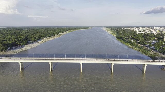 Aerial drone view approaching Haripur Bridge, showing the wide Gorai River, green riversides, and the surrounding landscape of Kushtia.