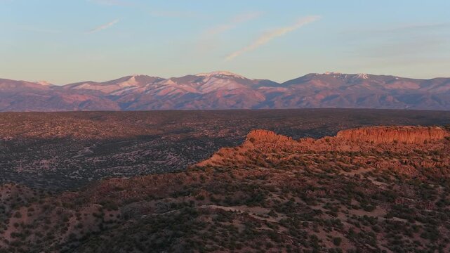 Aerial view of Mount Baldy in the Sangre de Cristo Mountains with desert scrub and evening light in Santa Fe, New Mexico, United States.