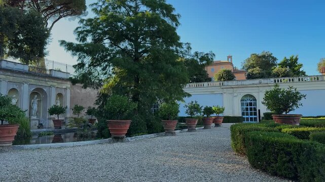 Rome, Italy - 07.30.2025 Panoramic view of Villa Doria Pamphilj historic garden with manicured hedges, potted plants and elegant architecture on a sunny day. Editorial use.
