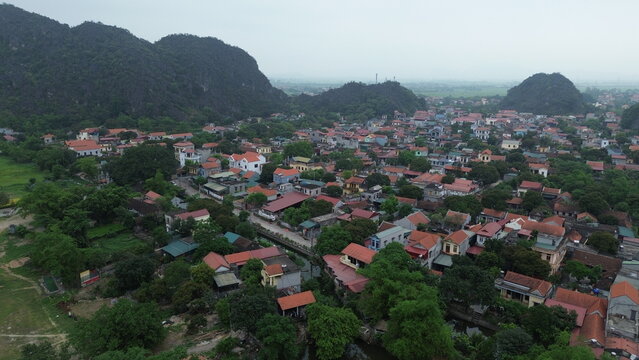 Aerial view of ancient capital Hoa Lu historic temples and stone gate nestled in limestone karsts, Ninh Binh, Vietnam