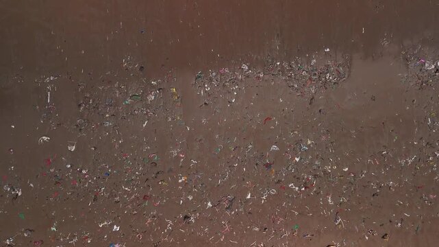 Aerial view of plastic waste scattered across the sandy beach in Indonesia representing pollution, sustainability challenges, and ecosystem damage