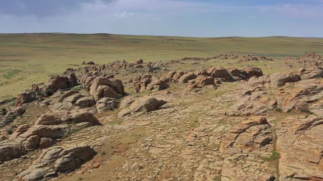 Aerial view of Baga Gazariin Chuluu rock formations in the vast steppe landscape of Dundgovi, Mongolia.