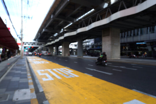 The lane markings, specifically the yellow lines at public transport stops, strictly prohibit drivers from overtaking other vehicles.