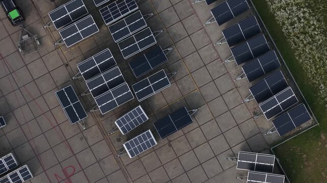 Aerial view of a mobile solar installation using photovoltaic panels to generate renewable electricity and charge batteries for off-grid energy storage.