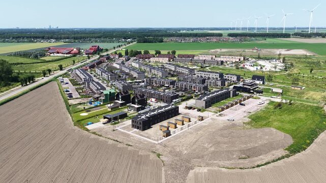 Aerial view of modern new build housing and residential development in Almere, the Netherlands, showing contemporary homes, streets and expanding urban neighborhoods.