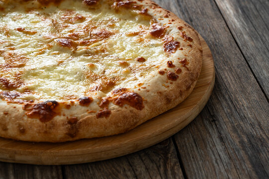 Pizza Bianca white pizza with oregano on wooden table
