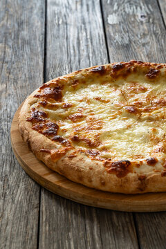 Pizza Bianca white pizza with oregano on wooden table
