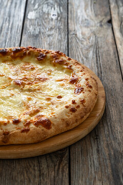 Pizza Bianca white pizza with oregano on wooden table
