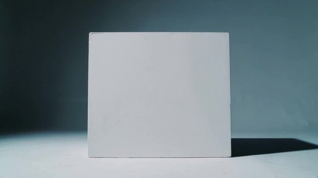 Showing plain white block receiving shifting striped shadows on pale tabletop, slatted panel moving