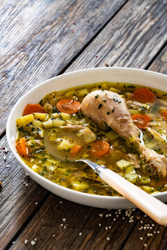 Krupnik - polish barley soup with chicken meat on wooden table
