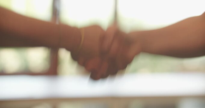 Close-up 4K video of two women shaking hands. Professional gesture representing agreement, partnership, trust, cooperation and successful business interaction.