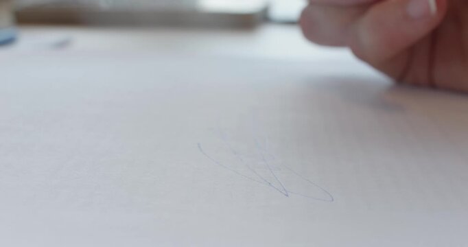Close-up 4K video of a female person signing a document with a pen on paper. Detailed shot representing agreement, authorization, contract signing, consent and official paperwork.