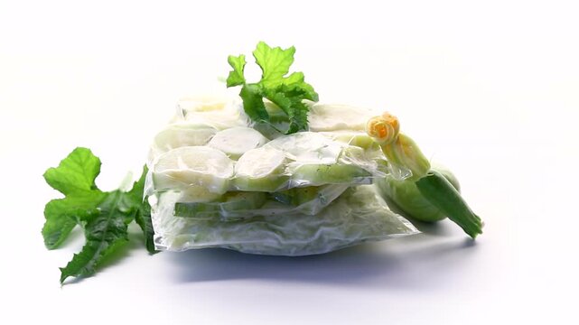 Vacuum packed zucchini slices with fresh vegetable and flower