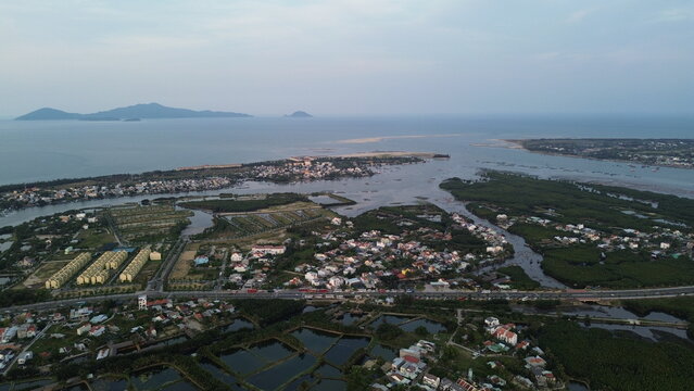 High altitude aerial view of Hoi An city and winding river tributaries in Thu Bon river delta, Vietnam