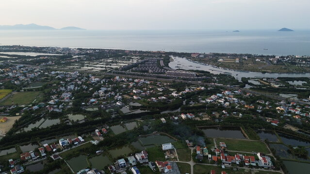 High altitude aerial view of Hoi An city and winding river tributaries in Thu Bon river delta, Vietnam