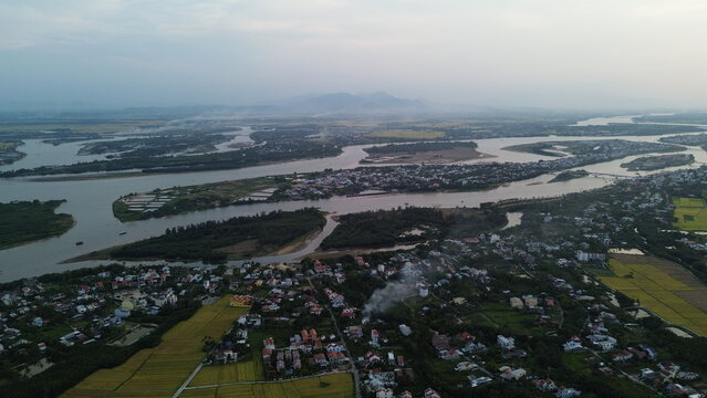 High altitude aerial view of Hoi An city and winding river tributaries in Thu Bon river delta, Vietnam