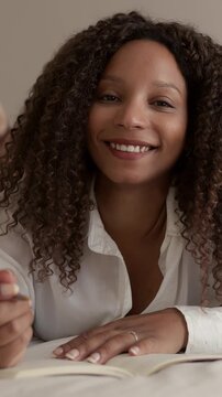 Beautiful young woman writing in journal