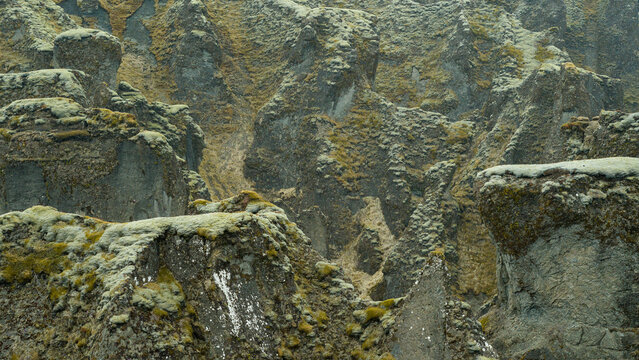 Moss-covered volcanic rock formations in Icelandic canyon