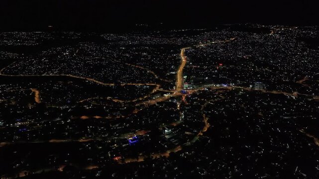 Aerial view of Kigali city lights at night with illuminated roads and urban sprawl in Kigali, Kigali City, Rwanda.