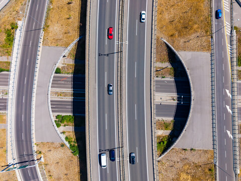 View of a busy highway interchange with vehicles traveling in different directions during daytime