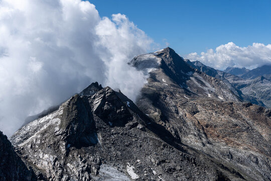 rugged alpine mountain peaks rising through dramatic clouds in a high altitude rocky landscape