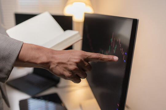 Professional financial analyst reviewing stock market charts across multiple screens using a tablet, laptop and calculator to evaluate price movements, technical indicators, and investment strategies.