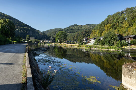Summer view of the picturesque Semois River as it winds slowly through Bohan-sur-Semois, in Namur, Belgium. Bohan is a popular vacation destination in the Ardennes Forest.