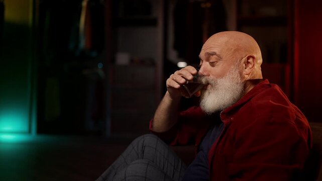 Lonely man drinks liquor on the floor, coping with depression after divorce