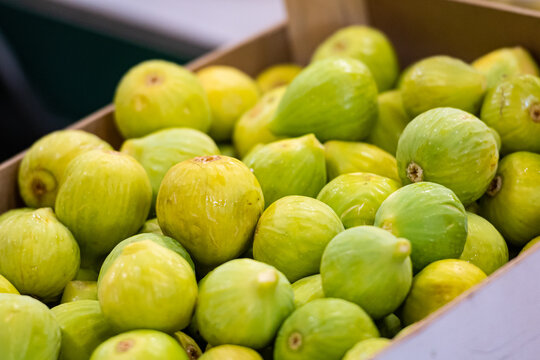 Fresh ripe green figs displayed in a box at a fruit and vegetable market in Bari, Puglia, Italy