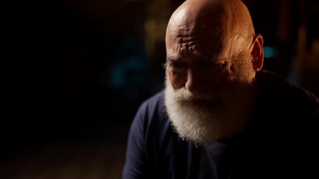 Heartbroken middle-aged man cries deeply at home, overwhelmed by loneliness