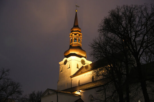 low-angle night view of the illuminated St. Mary's Cathedral in Tallinn with baroque spire