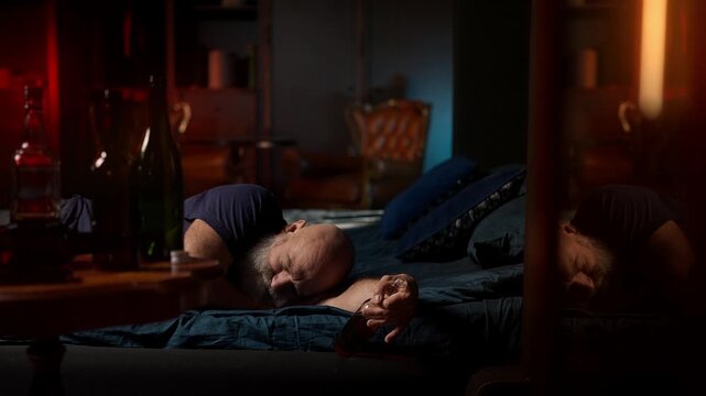 Man sleeps beside liquor bottle, struggling with depression and alcoholism