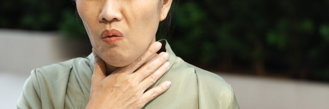 middle aged asian female suffering from cough and cold symptoms outdoors, weak and unwell, body parts closeup shot