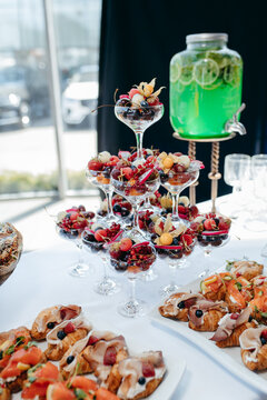 Food and drinks on corporate party table.