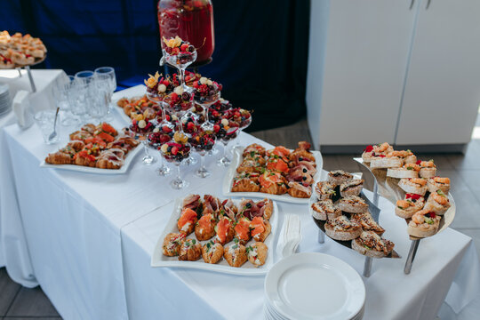 Food and drinks on corporate party table.