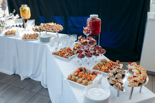 Food and drinks on corporate party table.