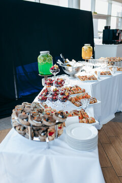 Food and drinks on corporate party table.