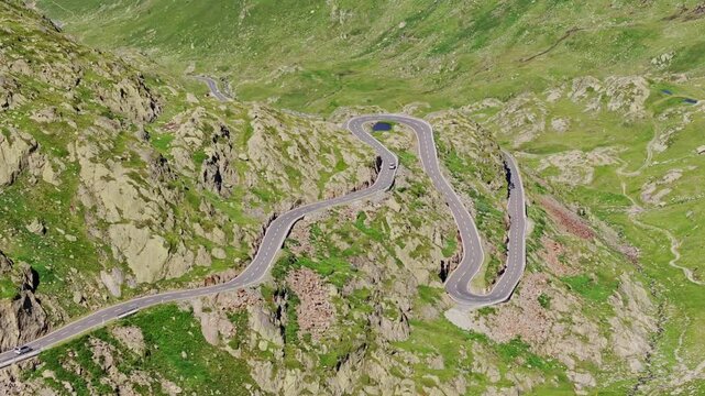 Serpentine highway curves through rugged slopes along the Swiss-Italian border