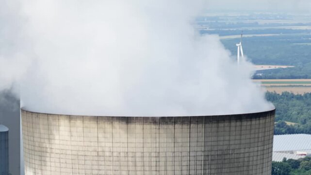 Aerial view of a massive lignite-fired power plant with large cooling towers, showing fossil fuel electricity generation, heavy industry and energy infrastructure.