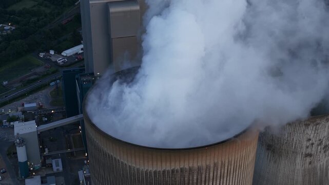 Aerial view of a massive lignite-fired power plant with large cooling towers, showing fossil fuel electricity generation, heavy industry and energy infrastructure.