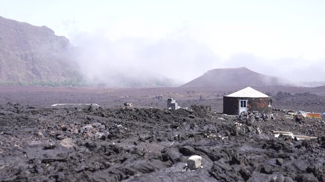 Volcanic Smoke Above Landscape of Fogo Island and Funco Traditional House in Grey Lava Fields, Cape Verde