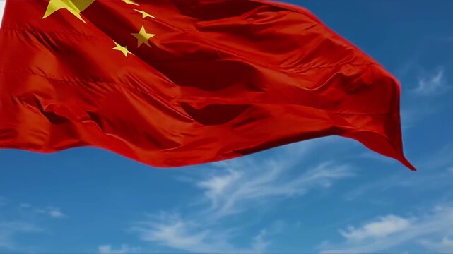 China National Day flag waving in the wind, showing the Chinese national symbol for a patriotic holiday, celebration, anniversary, cultural event, and international background.