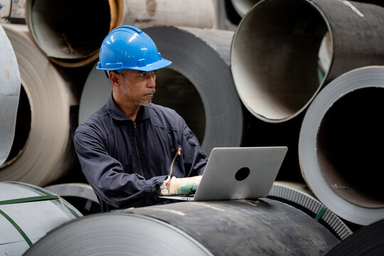 Worker engineer, Industrial Engineers in Hard Hats. Work at the Heavy Industry Manufacturing Factory. industrial worker indoors in factory. man working in an industrial factory. Safety first concept.