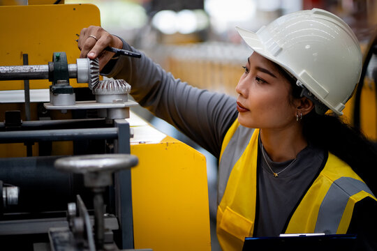 Happy women engineer worker enjoy working in factory industry.