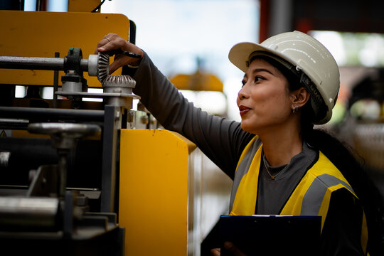 Happy women engineer worker enjoy working in factory industry.
