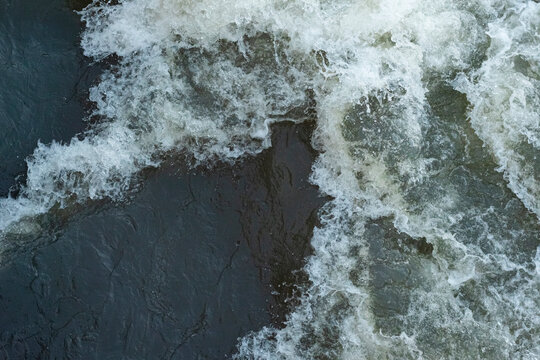 The streams make the bubbles look beautiful, Bubbles on the water, Surface for background, rough. Turbulent water texture with small bubbles.
