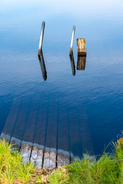 Handles from sunken ladder on wooden jetty