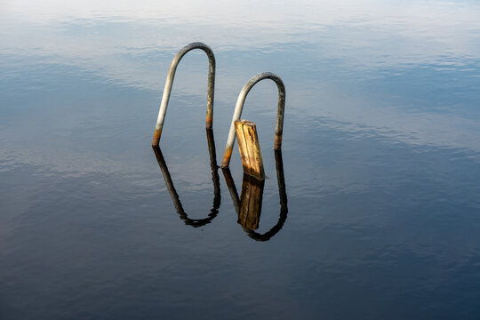 Handles from sunken ladder on wooden jetty